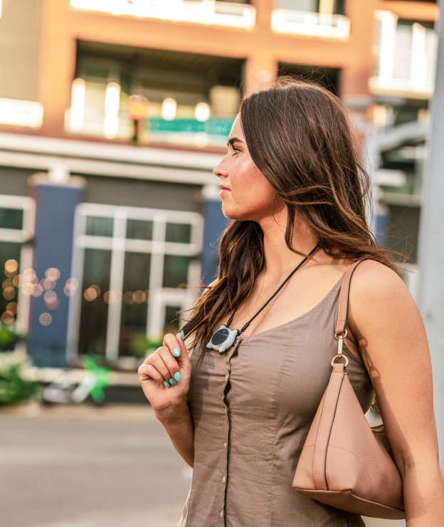 A woman wearing a white Looki L1 walks along a city street.